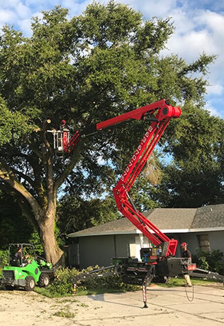 Tracked spider lift set up in a residential yard